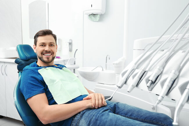 Happy Man Having Dentist’s Appointment In Modern Office